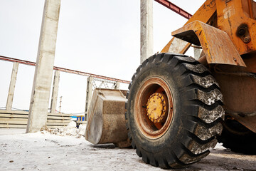 Fototapeta premium loader tractor wheel on construction site background
