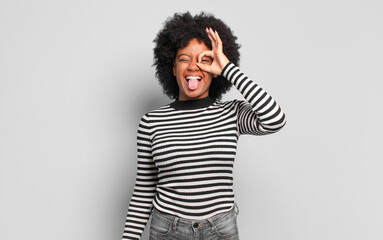  smiling happily with funny face, joking and looking through peephole, spying on secrets