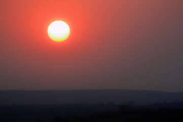 Fototapeta premium White hot sun and red sky at sunset.