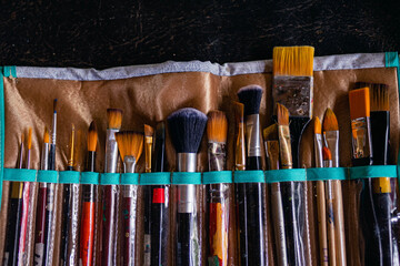 closeup of artist brushes with different sizes and shapes with nature background