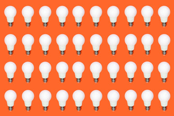 pattern of white light bulbs on an orange background. idea