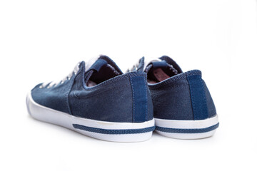 blue sneakers on white background with copy space. Youth shoes.
