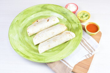 Traditional Mexican food in beautiful marbled colored plates on white wooden background
