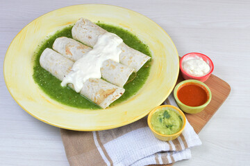 Traditional Mexican food in beautiful marbled colored plates on white wooden background