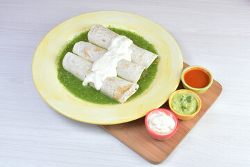 Traditional Mexican food in beautiful marbled colored plates on white wooden background