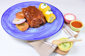 Traditional Mexican food in beautiful marbled colored plates on white wooden background