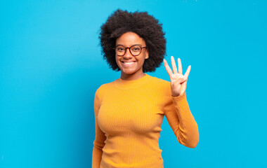  smiling and looking friendly, showing number four or fourth with hand forward, counting down