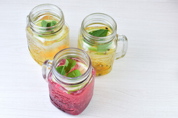 Colorful drinks, Italian sodas with ice, fruit flavors on white wooden background