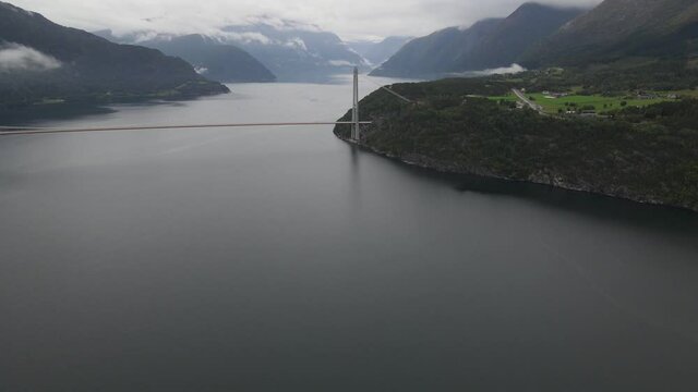 Closing up drone footage of Hardanger suspension bridge over a fjord. Western Norway