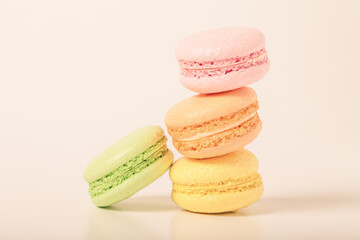 Colorful cake macaroons on a light background. Toned