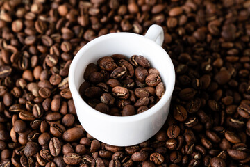 White cup and coffee beans. Closeup view