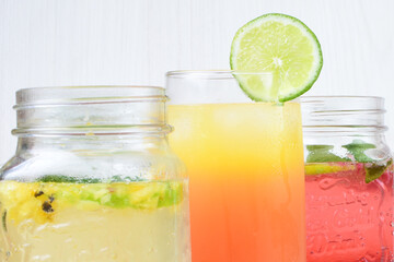 Colorful drinks, Italian sodas with ice, fruit flavors on white wooden background