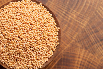 Bowl of Mustard Seeds on a Butcher Block