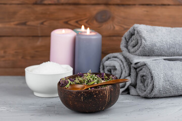 Obraz na płótnie Canvas Herbal therapy, traditional medicine and homeopathy concept. Towel with salt, herbs and aroma candles. Set for spa, massage and aromatherapy