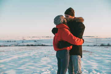 Couple kissing in snowy field