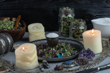 Fototapeta na wymiar Magic altar with mystical herbs, salt, candles and crystals. Witch sanctuary sacred esoteric concept.
