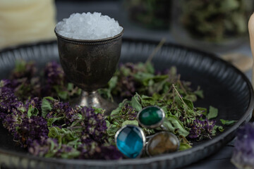 Magic altar with mystical herbs, salt, candles and crystals. Witch sanctuary sacred esoteric concept.