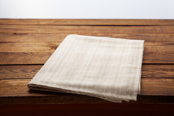 Empty canvas napkin on wooden desk top view