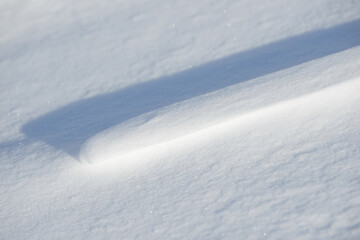 Obraz premium Fresh clean white snow background texture. Winter background with frozen snowflakes and snow mounds. Snow lumps. Seasonal landscape details. Cold weather.