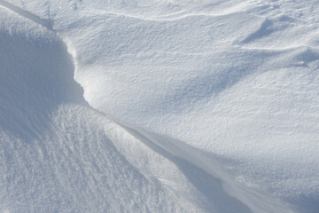 Fresh clean white snow background texture. Winter background with frozen snowflakes and snow mounds. Snow lumps. Seasonal landscape details. Cold weather.