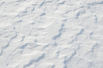 Fresh clean white snow background texture. Winter background with frozen snowflakes and snow mounds. Snow lumps. Seasonal landscape details. Cold weather.