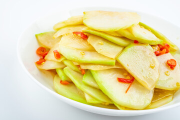 A dish of fried kohlrabi slices on white background