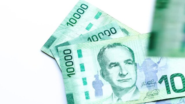 Currency Costa Rica banknotes falling and rotating slowly on their own axis. The concept of lottery and economics, Nominals after ten and twenty thousand Colones, white background