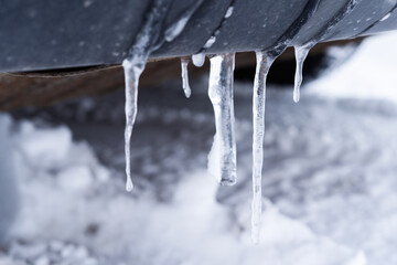 Naklejka na ściany i meble Ice icicles formed on a car in winter