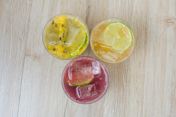 italian flavored sodas with ice and tropical flavors on white wooden background