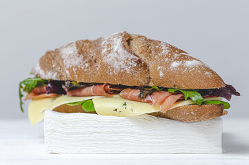 Homemade ham sandwich with arugula, lettuce and cheese Take away. Delivery food