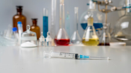 Photo Flasks with chemical powder, laboratory glassware with solutions on the table in the laboratory.