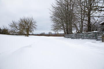 Snow covered the streets roads fences houses in the village. A large snowfall formed large drifts of snow.