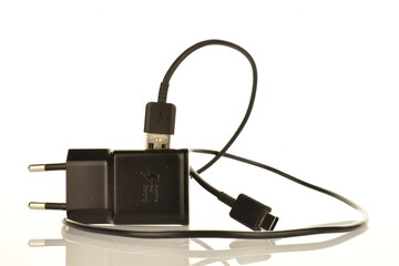 One black charger, close-up, isolated on white.