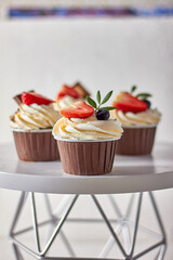 Cupcake decorated with strawberries and blueberries