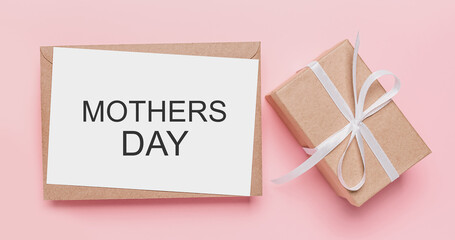 Gifts with note letter on isolated pink background, love and valentine concept with text mothers Day