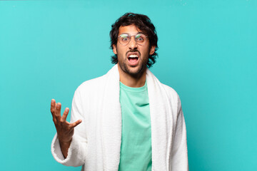 young handsome indian man looking angry, annoyed and frustrated screaming wtf or what’s wrong...