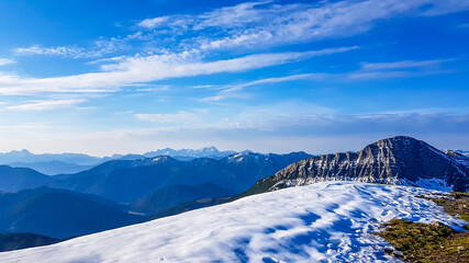 A panorama of a snow caped mountains Alps in Goldeck, Austria. Crispy and frosty morning. The ground is completely covered with snow. Endless mountain chains in the back. Serenity and solitude