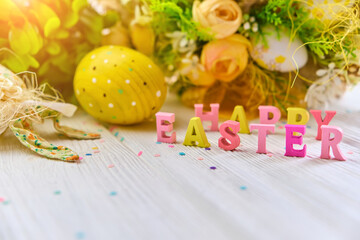 Colorful easter basket on a white wooden background