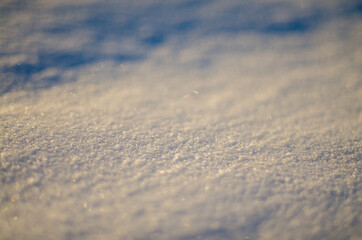 close up white snow in winter at sunset, snowy background