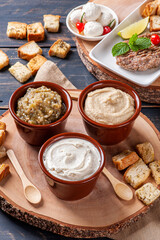 Obraz na płótnie Canvas .Meze is an oriental set of appetizers served in small bowls with babaganush, curd, hummus and kibbeh