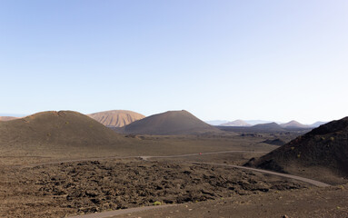 Volcanos on desert area at Timanfaya National Park. Volcanic natural landscape in Lanzarote island. Travel destination, tourism attraction concepts