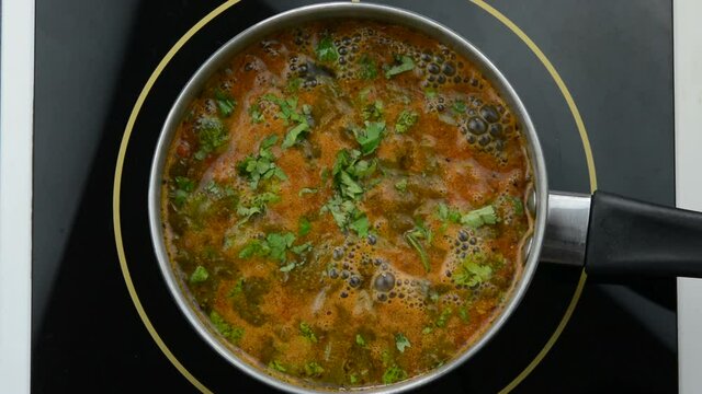 Preparing rasam, south indian spicy soup dish