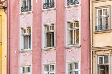 Lviv, Ukraine pink color wall pattern in historic Ukrainian Lvov city with colorful buildings abstract architecture on street in old town market square