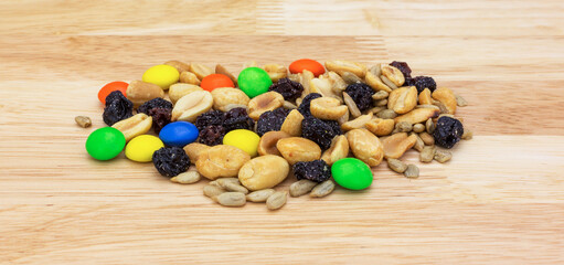 Side view of a portion of sweet and salty trail mix on a tabletop.