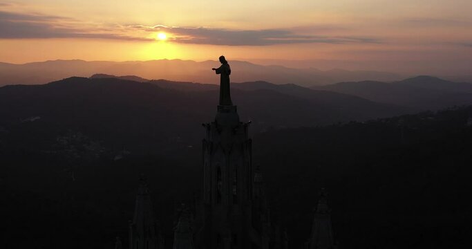 Aerial video withleft pan movement of half of tibidabo church with amazing sunset