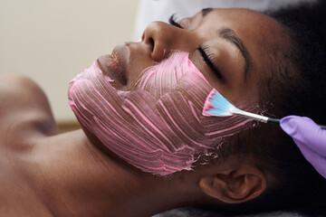 Spa beauty treatment, skincare. Woman getting facial care by beautician at spa salon. Young...