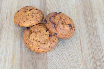 Cookies with brown chocolate on wooden background close up