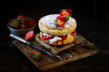 Victoria sponge cake with strawberries and white cream. Delicious famous dessert.