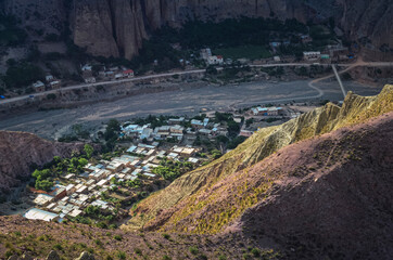 Fototapeta na wymiar Stock photo of the Iruya village between colored hills and mountains valley. Salta, Argentina. Colorful landscape