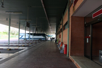 Exterior of a small bus station with buses waiting